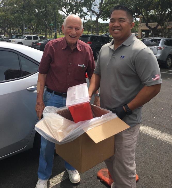 Sgt. Brian Stein of the HING Counterdrug Office safely disposes of some prescription drugs dropped off at the DEA National Take-Back Initiative