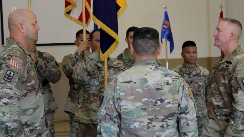 Hawaii Army National Guard Soldiers participate in the change of responsibility ceremony at 103D Troop Command, Waiawa, Hawaii November 2, 2019. Incoming Command Sgt. Maj. Bret D. Moore prepares to receive the “passing of the colors” as he replaces Command Sgt. Maj. Thomas Odoardi as Command Sgt. Maj. of the 103D Troop Command. (Photo by Hawaii Army National Guard Sgt. Matthew A. Foster)