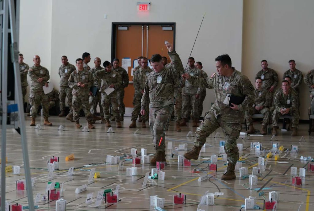Members of the 29th Infantry Brigade Combat Team from Hawai‘i, Guam, Alaska, Virginia, Utah, Georgia, Washington D.C., and California participate in a “Sand Table” mission brief during their joint Command Post Exercise (CPX), Kapolei Hawai’i, November 05, 2022. (US Hawai’i National Guard photo by Master Sgt. Andrew Lee Jackson)