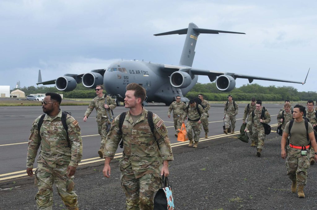 Total force Airmen from the 154th and 15th Aircraft Maintenance Groups arrive at the Pacific Missile Range Facility on March 7, 2023, at Barking Sands, Hawaii. Aircraft armament systems crews were transited to Kauai on a C-17 Globemaster III to help receive, rearm, and launch fighter aircraft within a condensed time window. (U.S. Air National Guard photo by Staff Sgt. John Linzmeier)