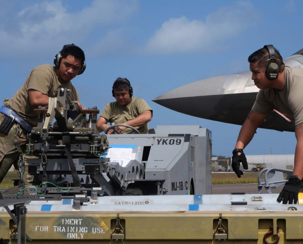 A Hawai’i Air National Guard weapons crew from the 154th Aircraft Maintenance Squadron arms an F-22 Raptor with inert munitions March 8, 2023, at the Pacific Missile Range Facility, Barking Sands, Hawaii. Aircraft armament systems crews from the 154th and 15th Aircraft Maintenance Squadrons were transited to Kauai on a C-17 Globemaster III to help receive, rearm, and launch fighter aircraft within a condensed time window. (U.S. Air National Guard photo by Staff Sgt. John Linzmeier)