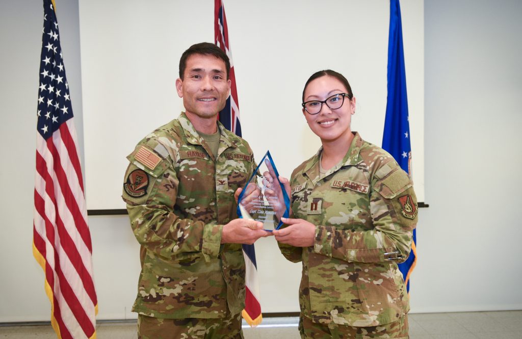 Col. Glen Hayase, 154th Mission Support Group deputy commander and 154th Force Support Squadron commander, presents the National Guard Bureau Force Support Reserve Component Company Grade Officer of the Year Award (Installation Level) to Captain Tina Kanatus March 2, 2024, at Joint Base Pearl Harbor- Hickam, Hawaii. Kanatus is the first known Guardsman to take home this national-level award for the second year running, demonstrating unparalleled leadership and adaptability for the years of 2022 and 2023. Beyond her exceptional performance in assignments within the Pacific Air Force’s Inspector General Team and her instrumental role in the administration of Talisman Sabre, her ongoing management of accountability for Joint Task Force-Red Hill stands as a testament to her enduring impact and invaluable contributions to mission success. (U.S. Air National Guard photo by Tech. Sgt. John Linzmeier)