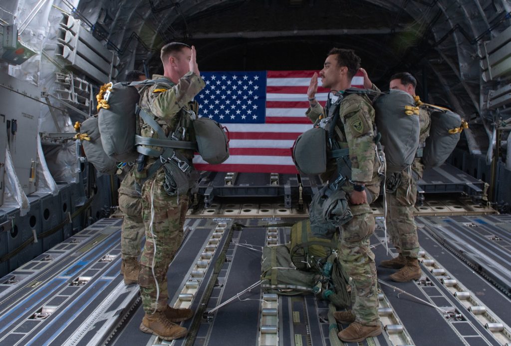 U.S. Army Lt. Col Jacob Hughes, 1st Squadron (Airborne), 40th Cavalry Regiment, Squadron Commander administers the Oath of Enlistment to Staff Sgt. Ryan McKinley, Black Hawk Troop, Section Leader, onboard a U.S. Air Force C-17 III over Anchorage, Alaska, Nov. 2, 2023. Training alongside the Joint Force and our Allies and Partners develops leaders and Soldiers, strengthening units and individuals. (U.S. Air National Guard photo by Airman 1st Class Roann Gatdula)