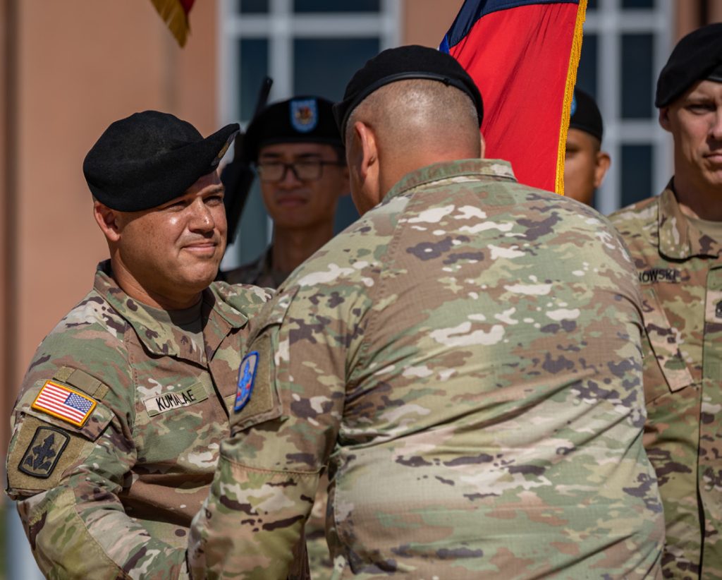 U.S. Army Command Sgt. Maj. Brandon I. Kumalae, incoming command sergeant major of the 29th Infantry Brigade Combat Team (IBCT), Hawaii Army National Guard, receives the guidon from Col. David T. Hatcher, commander of the 29th IBCT, during the 29th IBCT change of responsibility ceremony, Kapolei, Hawaii, Jan. 7, 2024. The change of responsibility ceremony is a time-honored tradition within the Army that commemorates the relinquishment of responsibility by passing the unit’s colors from one senior noncommissioned officer to another. (U.S. Army National Guard photo by Sgt. Lianne M. Hirano)