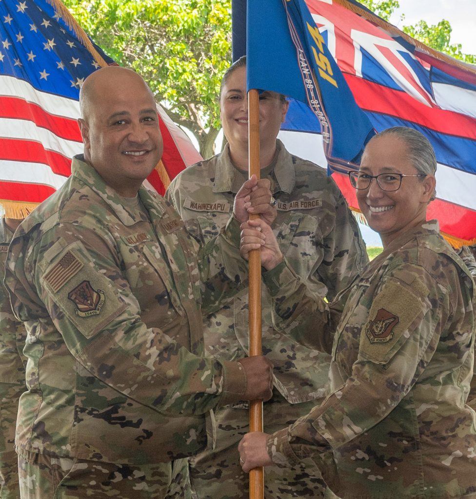 U.S. Air Force Brig. Gen. Phillip L. Mallory, 154th Wing commander, passes the guidon of the 154th Medical Group to Lt. Col. Elzadia Kaina, 154th Medical Group commander, on May 7, 2023 at Joint Base Pearl HarborHickam, Hawaii. Kaina makes history as the first female commander of the 154th Medical group. The 154th Medical Group is responsible for the medical readiness of all Airmen assigned to 30 local and geographically separated units across four islands of Hawaii. (U.S. Air National Guard photo by Airman 1st Class Roann Gatdula