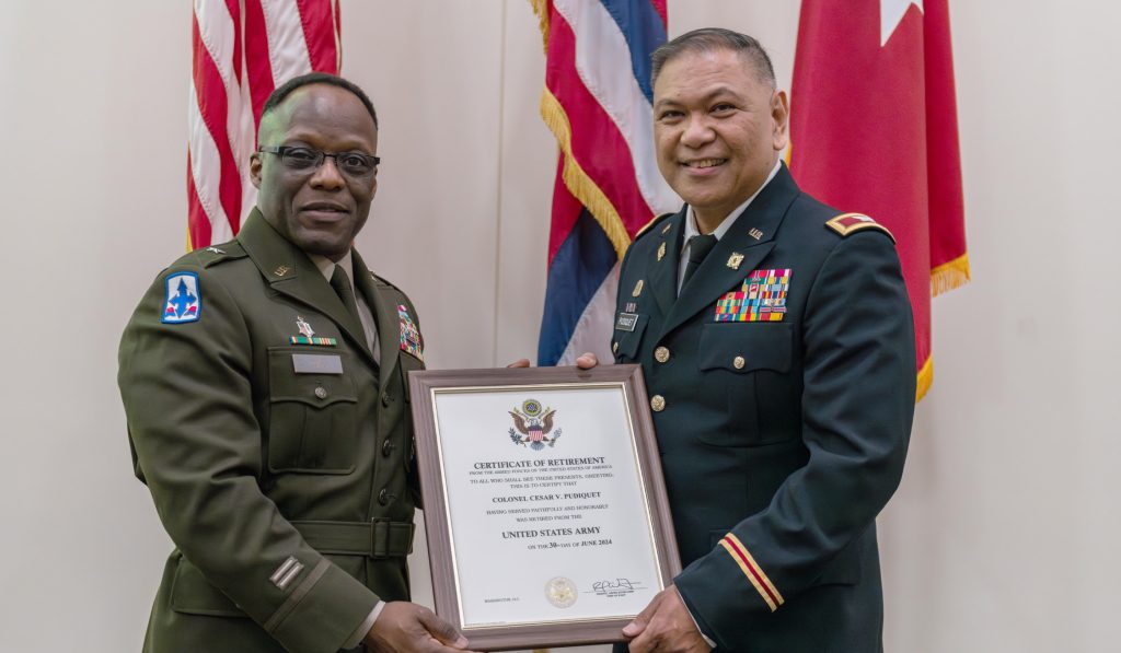 U.S. Army Brig. Gen. Walter R. Ross Jr., delivers the certificate of retirement to Col. Cesar V. Pudiquet at the 29th Infantry Brigade Combat Team Readiness Center in Kapolei, Hawai‘i, June 28, 2024. Pudiquet enlisted in the Hawai‘i Air National Guard in 1986 and transferred to the Hawai‘i Army National Guard in 1999, completing 37 years and 10 months of service before retiring. Pudiquet served in multiple state response missions to include commander of Task Force Kauai, supporting the 2018 Wainiha Flood Emergency; commander of Task Force Hawai‘i, supporting the 2018 Kilauea volcanic eruption; commander of Task Force Maui during the COVID-19 response; and the J4 - logistics officer for the Joint Task Force 5-0, supporting the Maui wildfire response in 2023, making him one of only a few HIARNG officers to command troops on every county within the State of Hawai‘i. (U.S. Army National Guard photo by Sgt. John Schoebel)