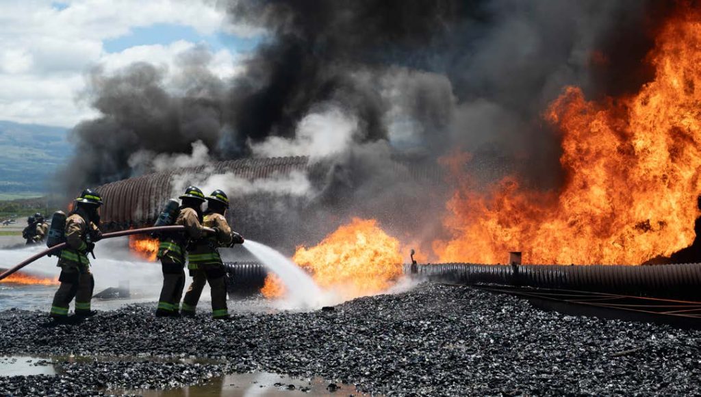 During the month of September, the 297th Engineer Fire & Emergency Services Team, Hawai‘i Army National Guard, conducted aircraft rescue firefighting training with the 624th Civil Engineer Squadron, Marine Corp Air Station Kaneohe, Maui County, and State Crash Rescue on Maui. The training simulated a downed cargo aircraft on fire, where firefighters utilized water to increase the number of repetitions in offensive sweeps and suppression. The Fire and Emergency Services team organized 3-man teams consisting of a fire officer, a nozzleman and a back-up firefighter. (Photo by Air Force Senior Airman Victoriya Tarakanova, 624th Regional Support Group)