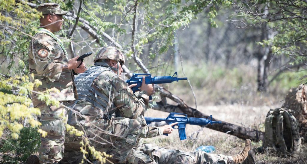 An exercise cadre monitors Airmen protecting an injured member during field training at Joint Base Pearl Harbor-Hickam, Hawaii, on Feb. 2, 2025. The exercise not only tested the Airmen’s tactical abilities but also emphasized the importance of mental resilience and quick decision-making under pressure. These exercises are critical for maintaining the operational excellence and readiness of the 154th Mission Support Group, ensuring that they remain prepared for any eventuality. (U.S. Air National Guard photo by Staff Sgt. Robert Cabuco)