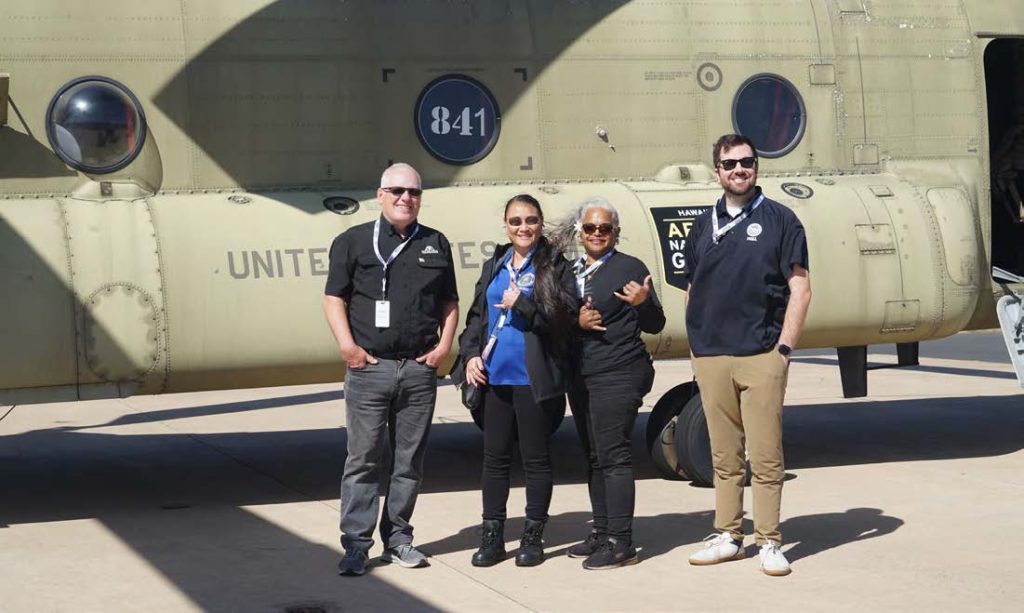 Hawai‘i National Guard employers pose in front of the chinook after conducting a safety brief. (Photo by Rachel Blaire)