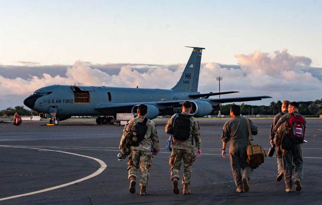 U.S. Air Force Airmen from the 203rd Air Refueling Squadron and the 169th Air Defense Squadron approach a U.S. Air Force KC-135 Stratotanker assigned to the 203rd Air Refueling Squadron at Joint Base Pearl Harbor-Hickam, Hawaii, on Feb. 5, 2025 for Sentry Aloha 25-1. Fighter jets, tankers, and support units participated in simulated combat scenarios, enhancing interoperability and readiness among U.S. military forces. (U.S. Air National Guard photo by Senior Airman Roann Gatdula)