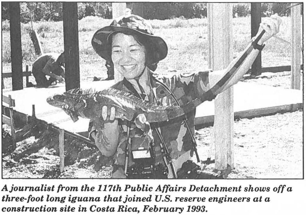 A journalist from the 117th Public Affairs Detachment shows off a three-foot long iguana that joined U.S. reserve engineers at a construction site in Costa Rica, February 1993. (State of Hawai‘i Department of Defense archive photo)