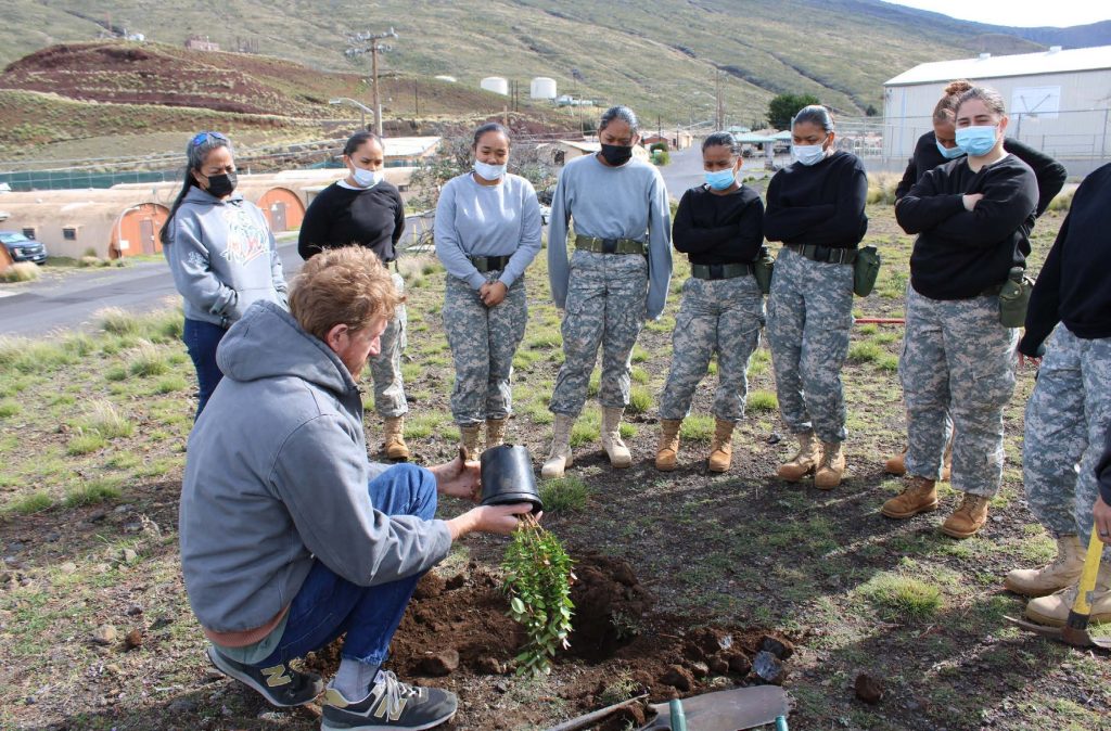 David Cole botanical program manager with the Center of Military Environmental Land Management (CEMML) showing Youth Challenge Academy cadets the proper way to plant a tree at U.S. Army Garrison Pōhakuloa Training Area, February 23, 2023.
