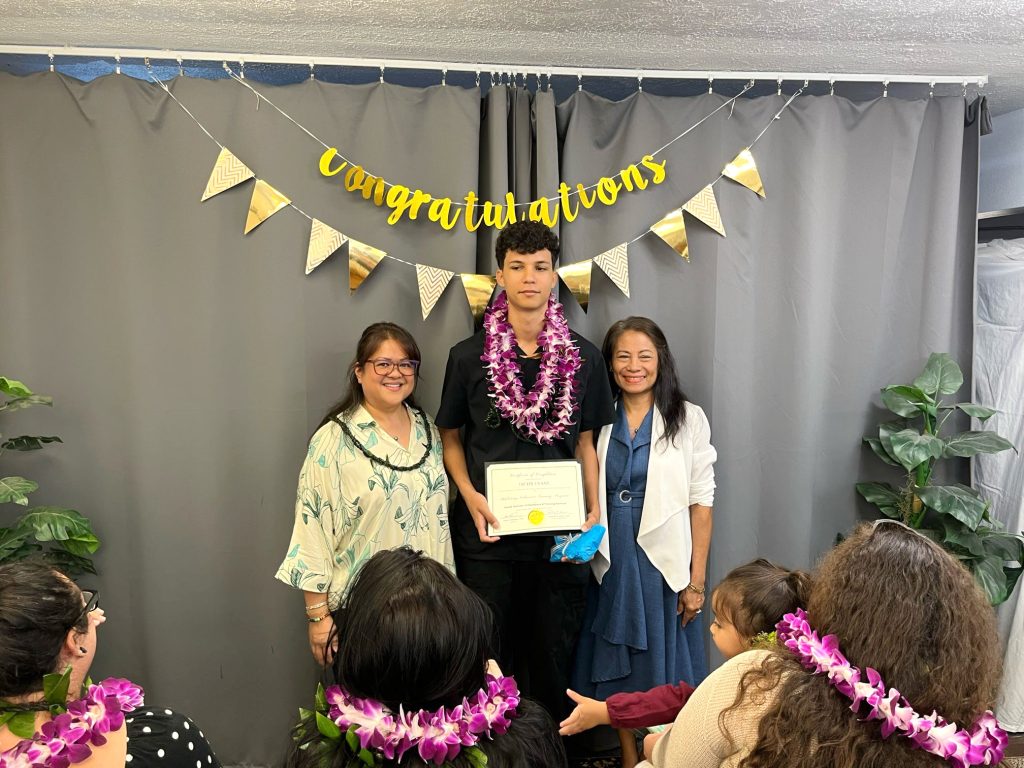 Hawai‘i Job Challenge Academy Associate Jacob Evans at his phlebotomy graduation on March 9, with Hawaii Institute of Healthcare & Training Services instructors. (Hawai‘i Job Challenge Academy photo by Deputy Director James Spray Jr.)