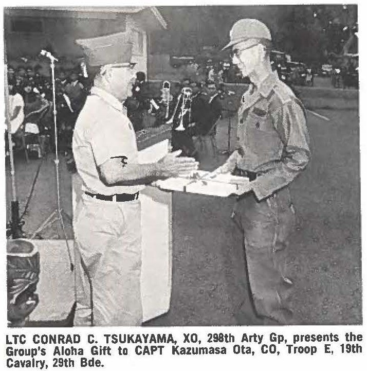 LTC CONRAD C. TSUKAYAMA, XO, 298th Arty Gp, presents the Group's Aloha Gift to CAPT Kazumasa Ota, CO, Troop E, 19th Cavalry, 29th Bde.