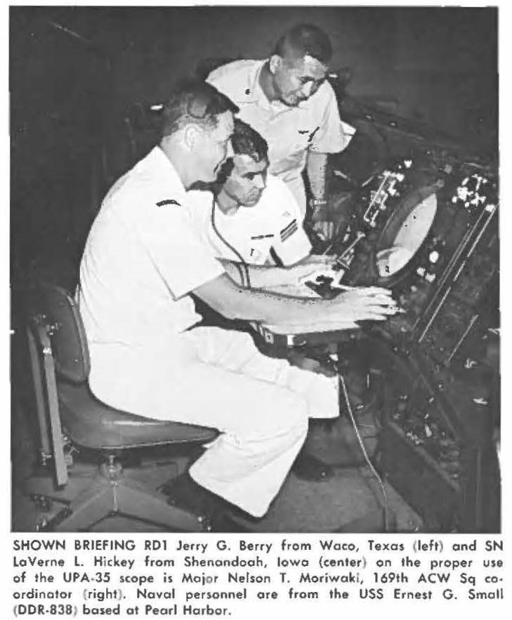 SHOWN BRIEFING RD1 Jerry G. Berry from Waco, Texas (left) and SN LoVerne L. Hickey from Shenandoah, Iowa (center) on the proper use of the UPA-35 scope is Major Nelson T. Moriwaki, 169th ACW Sq coordinator (right). Naval personnel are from the USS Ernest G . Small (DDR-838) based at Pearl Harbor.
