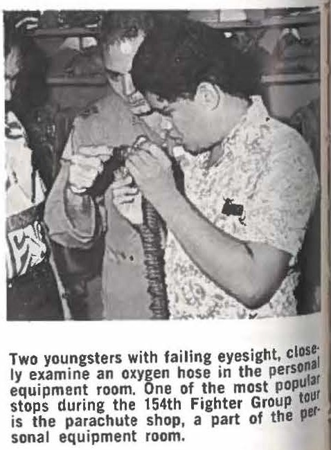 Two youngsters with failing eyesight, closely examine an oxygen hose in the personal equipment room. One of the most popular tour stops during the 154th Fighter Group tour is the parachute shop, a part of the personal equipment room.