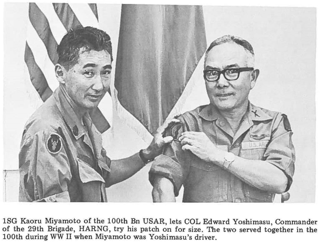 1SG Kaoru Miyamoto of the 100th Bn USAR, lets COL Edward Yoshimasu, Commander of the 29th Brigade, HARNG, try his patch on for size. The two served together in the 100th during WW II when Miyamoto was Yoshimasu's driver.