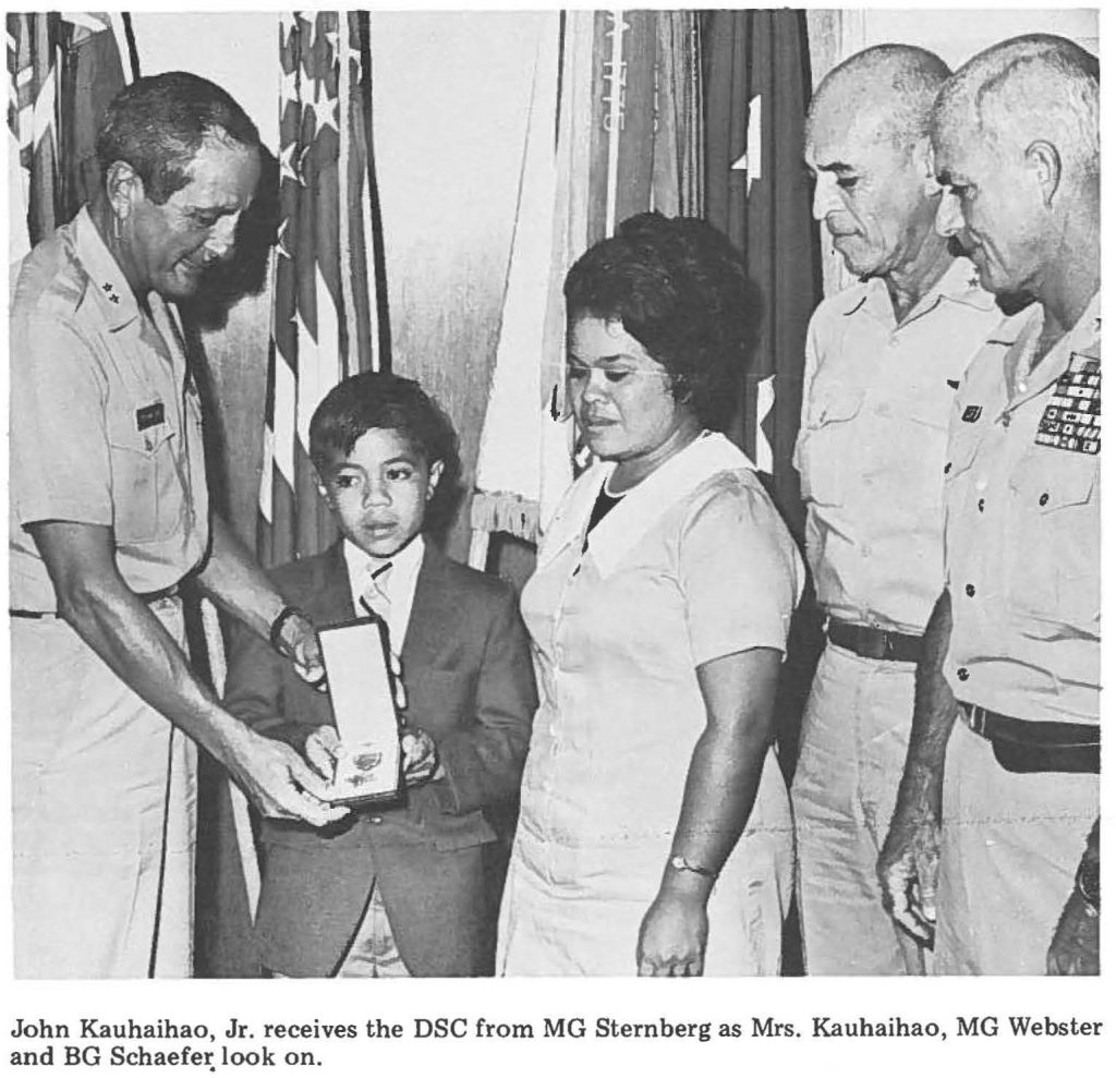 John Kauhaihao, Jr. receives the DSC from MG Sternberg as Mrs. Kauhaihao, MG Webster and BG Schaefer look on.