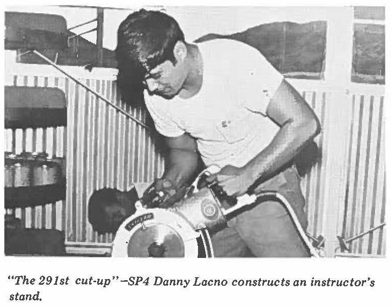 "The 291st cut-up"-SP4 Danny Lacno constructs an instructor's stand.