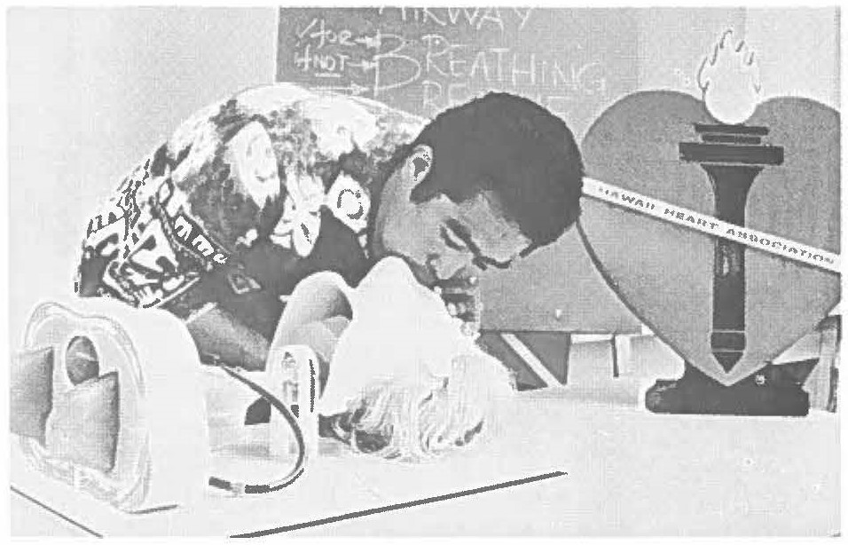 compulsory resuscitation includes artificial respiration as well as heart massage. Guy instructs students in applying CPR to both adults and infants