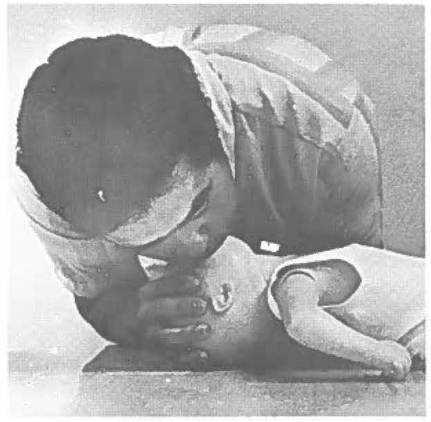 compulsory resuscitation includes artificial respiration as well as heart massage. Guy instructs students in applying CPR to both adults and infants