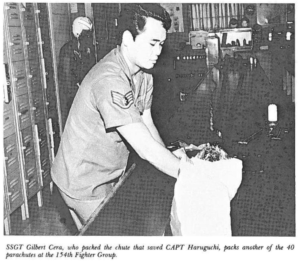 SSGT Gilbert Cera, who packed the chute that saved CAPT Haruguchi, packs another of the 40 parachutes at the 154th Fighter Group.