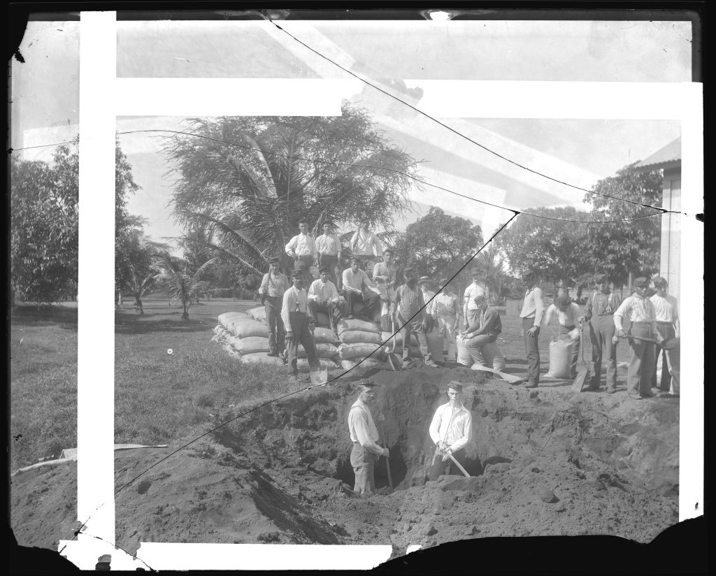1893. Filling bags with black sand to barricade the palace from attacks of Royalists, when the demands of President Cleveland to restore Queen Liliuokalani as Sovereign of Hawaii, Co. E. 1st Regiment National Guard Hawaii