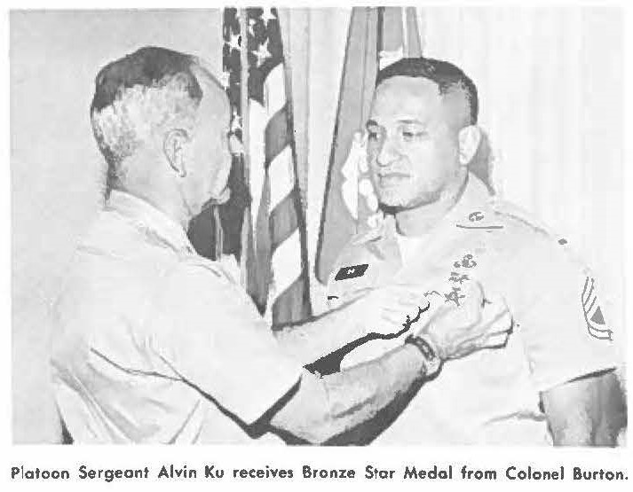 Platoon Sergeant Alvin Ku receives Bronze Star Medal from Colonel Burton.