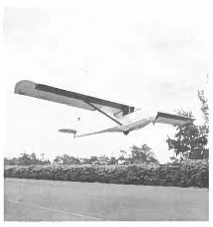 PILOTS AT DILLINGHAM parked their supersonic aircraft after a hard
day's work and took courtesy rides in a glider piloted by Tom Winkler,
well-known Island soaring enthusiast. One pilot, Major John Carroll,
received his solo certificate from Winkler. Glider was towed by automobile on taxiway; when glider reached altitude, pilot released tow cable.