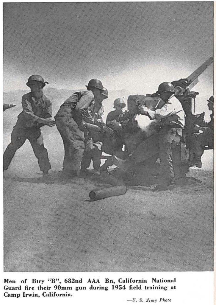 Men of Btry "B", 682nd AAA Bn, California National Guard fire their 90mm gun during 1954 field training at Camp Irwin, California.