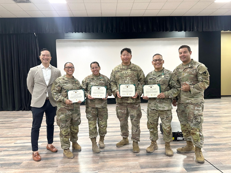 teammembers of the 1950th CCT stand proudly after receiving the Army Commendation Medal from Maj. Robert Frank at Camp Arifjan, Kuwait during Operation Spartan Shield. Pictured left to right: Mr. Kit Ariyat (Contracting Deputy), Staff Sgt. Genavi Oshiro, Staff Sgt. Stephanie Takayesu, Staff Sgt. Jonathan Yi, Staff Sgt. Joseph Sumang, Maj. Robert Frank. (1950th Support Detachment photos)