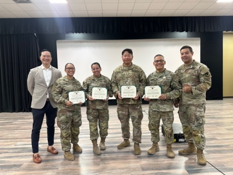Soldiers of the 1950th Contingency Contracting Team (1950th CCT) stand proudly after receiving the Army Commendation Medal from Maj. Robert Frank at Camp Arifjan, Kuwait during Operation Spartan Shield. Pictured left to right: Mr. Kit Ariyat (Contracting Deputy), Staff Sgt. Genavi Oshiro, Staff Sgt. Stephanie Takayesu, Staff Sgt. Jonathan Yi, Staff Sgt. Joseph Sumang, Maj. Robert Frank. Their professionalism, dedication, and mission success were recognized with this award, highlighting the impact 1950th CCT continues to make in support of the Army mission.