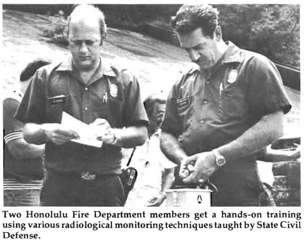 Two Honolulu Fire Department members get a hands-on training using various radiological monitoring techniques taught by State Civil Defense.