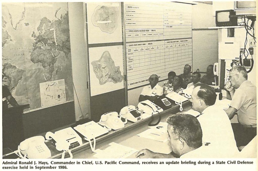 Admiral Ronald J. Hays, Commander in Chief, U.S. Pacific Command, receives an update briefing during a State Civil Defense exercise held in September 1986.