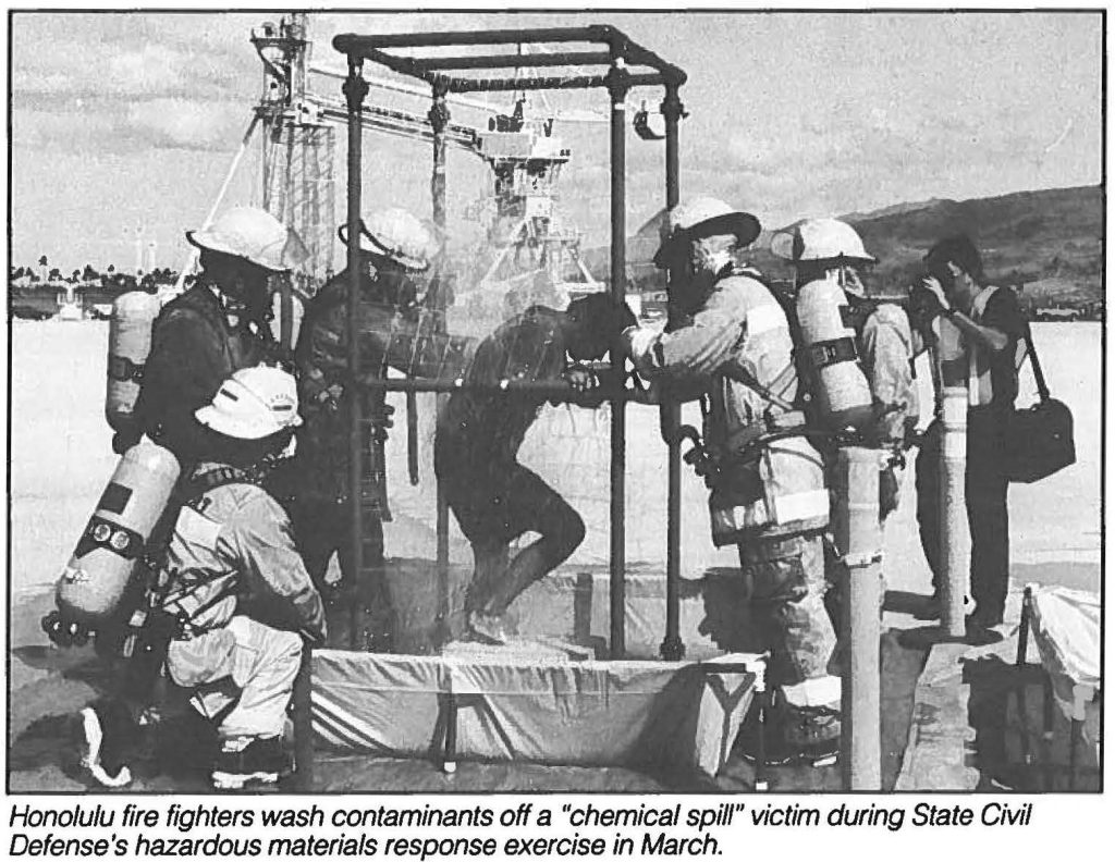 Honolulu fire fighters wash contaminants off a "chemical spill" victim during State Civil Defense's hazardous materials response exercise in March.
