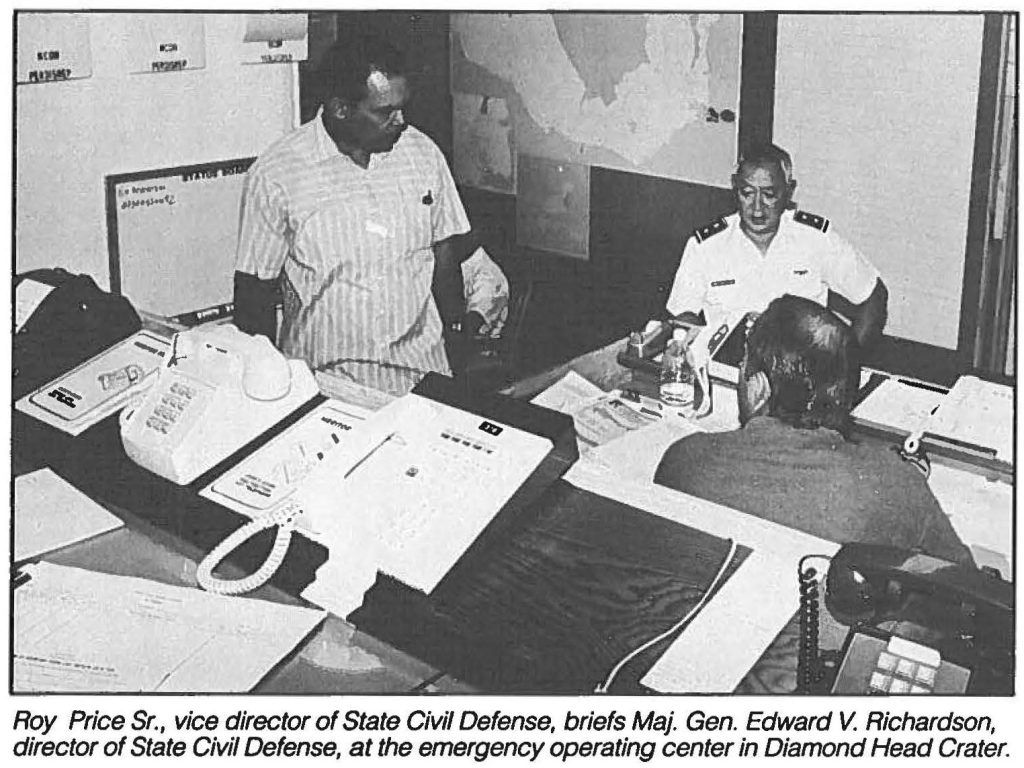 Roy Price Sr., vice director of State Civil Defense, briefs Maj. Gen. Edward V. Richardson, director of State Civil Defense, at the emergency operating center in Diamond Head Crater.