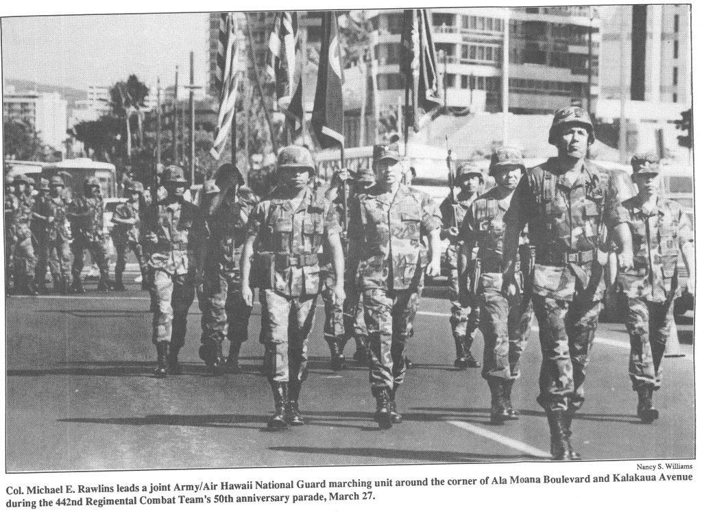 Col. Michael E. Rawlins leads a joint Army/ Air Hawaii National Guard marching unit around the corner of Ala Moana Boulevard and Kalakaua Avenue during the 442nd Regimental Combat Team's 50th anniversary parade, March 27.