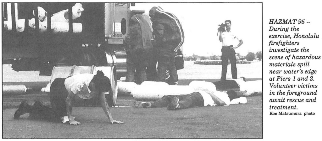 HAZMAT95-- During the exercise, Honolulu firefighters investigate the scene of hazardous materials spill near water's edge at Piers 1 and 2. Volunteer victims in the foreground await rescue and treatment. Ron Matsumura photo