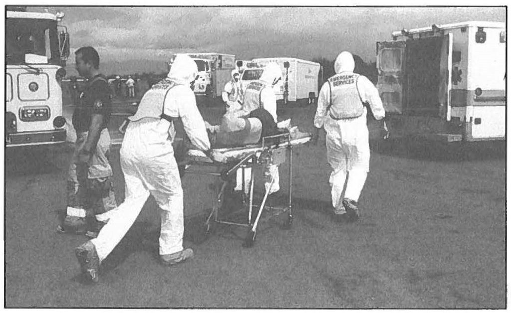 AMBULANCE TO THE RESCUE -- During a hazardous materials exercise an ambulance crew prepares to transport a victim to a hospital emergency room, after a chemical accident in Honolulu Harbor. Ron Matsumura photo