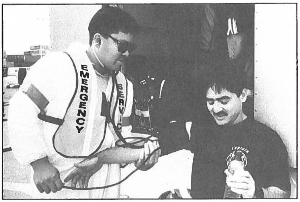 CHECKING FOR SIGNS -- A local firefighter checks for signs of heat stress during HAZMAT Exercise '95, Operation Diamond Head. Ron Matsumura photo