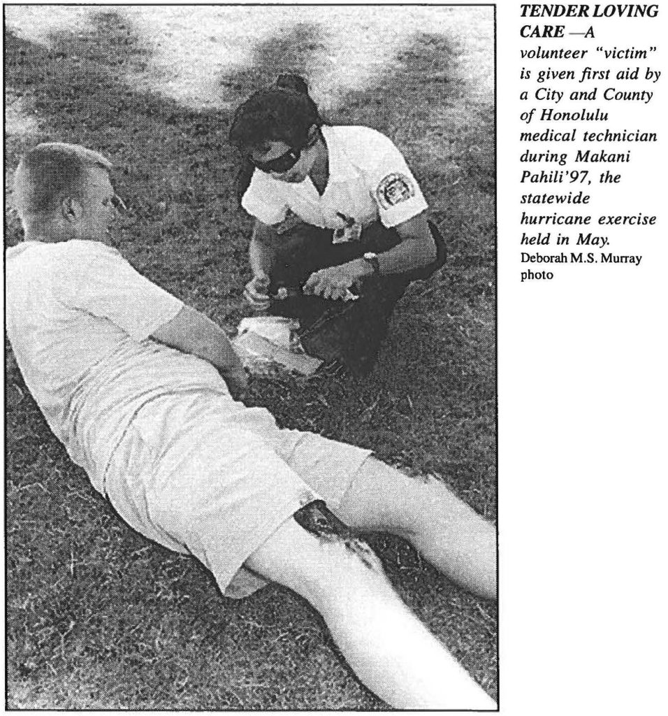 TENDER LOVING CARE - A volunteer "victim" is given first aid by a City and County of Honolulu medical technician during Makani Pahili '97, the statewide hurricane exercise held in May. Deborah M.S. Murray photo
