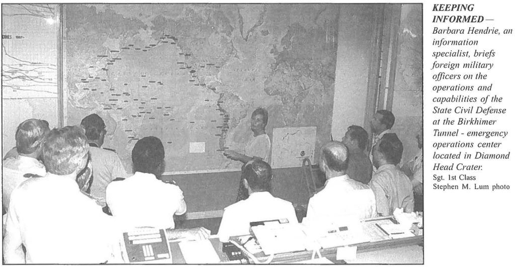 KEEPING INFORMED - Barbara Hendrie, an information specialist, briefs foreign military officers on the operations and capabilities of the State Civil Defense at the Birkhimer Tunnel - emergency operations center located in Diamond Head Crater: Sgt. 1st Class Stephen M. Lum photo