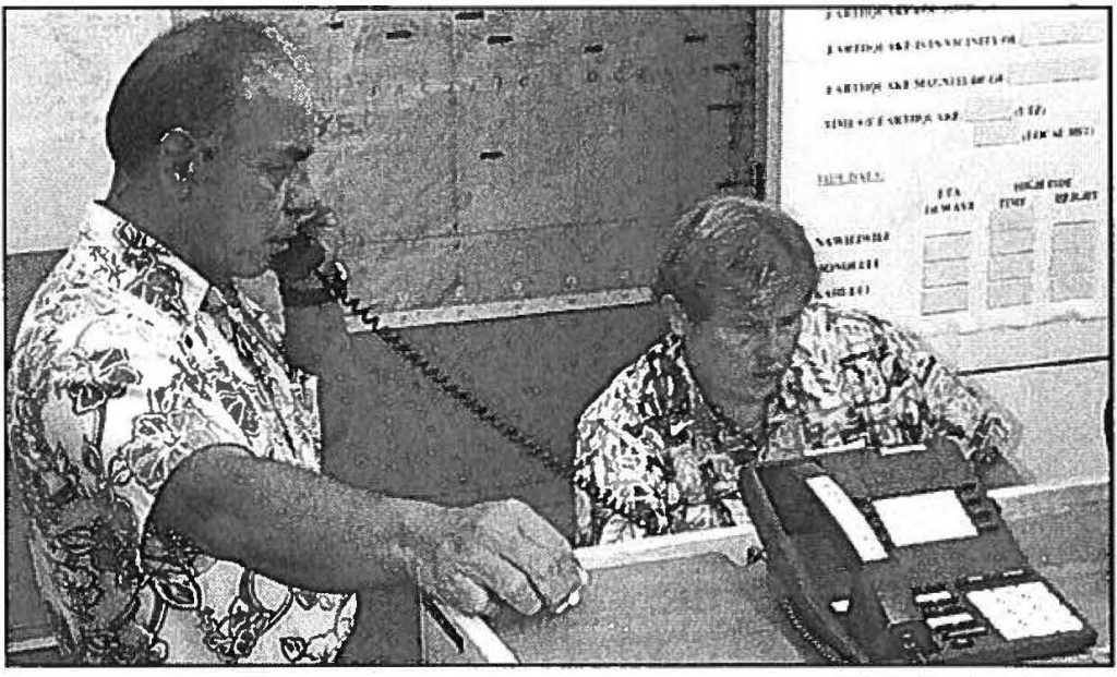 IN THE LOOP - Vice director Edward T. Teixeira confers with emergency operations staff during state activation for Sept. 11. State Civil Defense photo