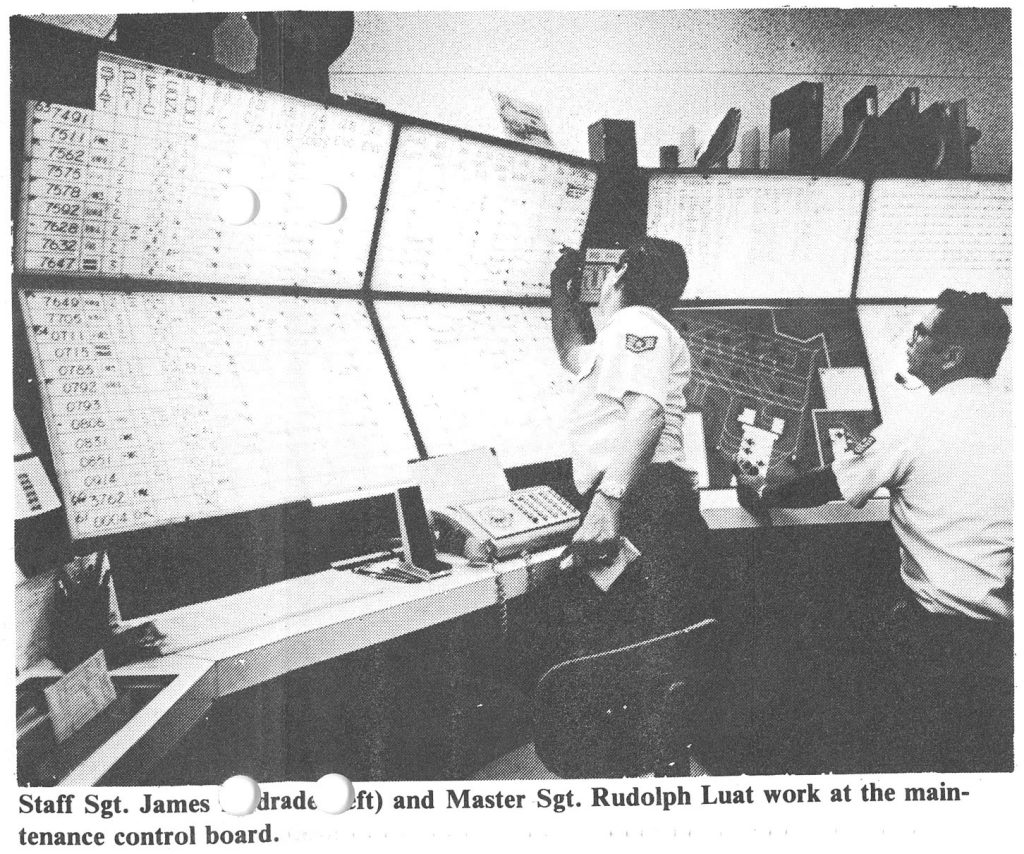 Staff Sgt. Janes . . drade . . eft and Master Sgt. Rudolph Luat work at the maintenance control board