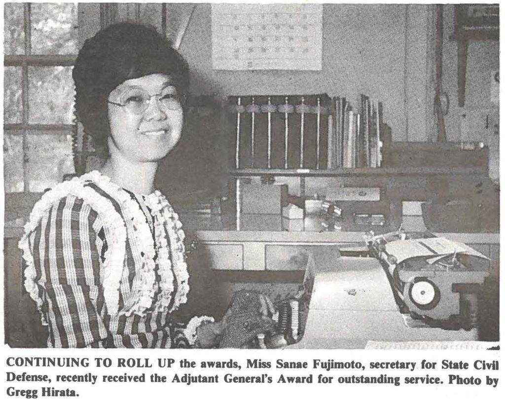 CONTINUING TO ROLL UP the awards, Miss Sanae Fujimoto, secretary for State CMI Defense, recently received the Adjutant General's Award for outstanding service. Photo by Gregg Hirata.