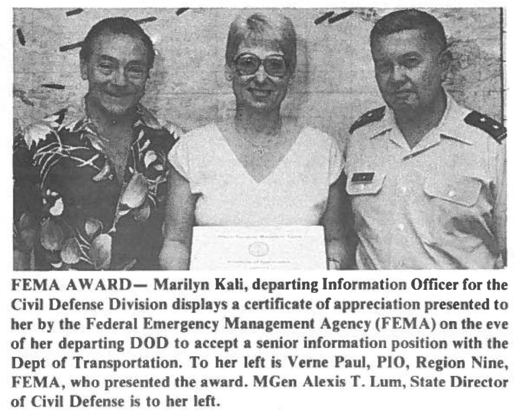 FEMA AWARD- Marilyn Kali, departing Information Officer for the Civil Defense Division displays a certificate of appreciation presented to her by the Federal Emergency Management Agency (FEMA) on the eve of her departing DOD to accept a senior information position with the Dept of Transportation. To her left is Verne Paul, PIO, Region Nine, FEMA, who presented the award. MGen Alexis T. Lum, State Director of Civil Defense is to her left.