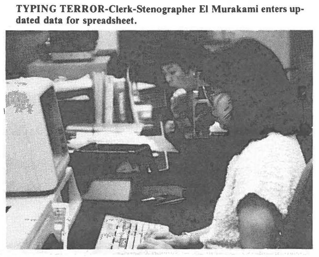 TYPING TERROR-Clerk-Stenographer El Murakami enters updated data for spreadsheet.