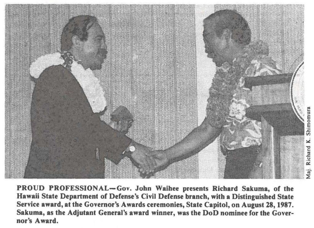 PROUD PROFESSIONAL-Gov. John Waihee presents Richard Sakuma, of the Hawaii State Department of Defense's Civil Defense branch, with a Distinguished State Service award, at the Governor's Awards ceremonies, State Capitol, on August 28, 1987. Sakuma, as the Adjutant General's award winner, was the DoD nominee for the Governor's Award.