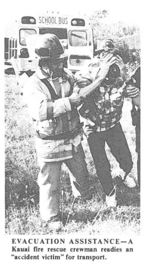 EVACUATION ASSISTANCE-A Kauai fire rescue crewman readies an "accident victim" for transport.