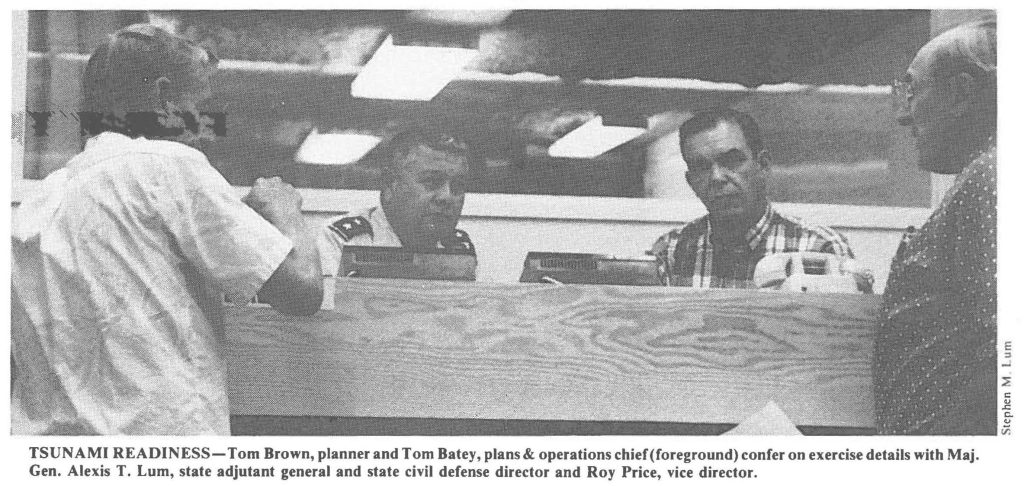 TSUNAMI READINESS-Tom Brown, planner and Tom Batey, plans & operations chief (foreground) confer on exercise details with Maj. Gen. Alexis T. Lum, state adjutant general and state civil defense director and Roy Price, vice director.